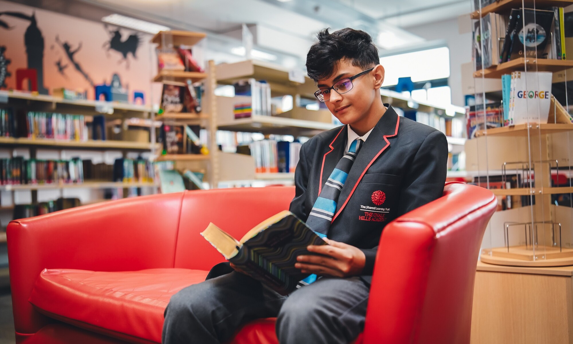 The Chalk Hills Academy pupil reading in the school library